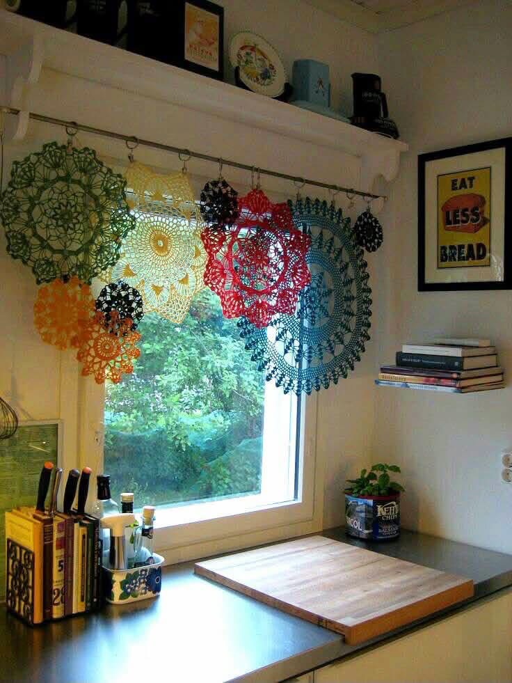 Colorful doilies forming a valance over a kitchen window