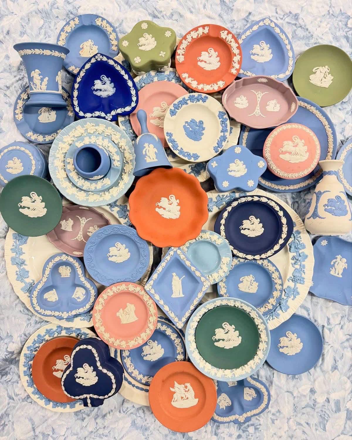 Flat lay of multicolored Jasperware plates, boxes and vases