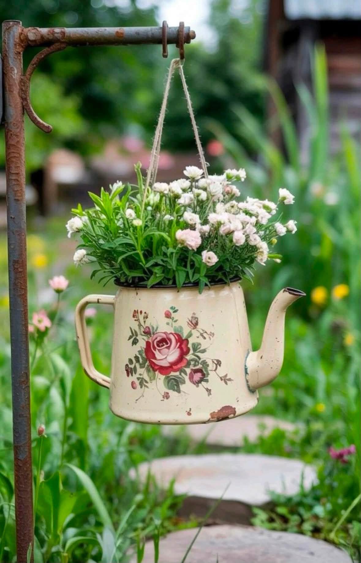 Flowers in a hanging floral enamel teapot