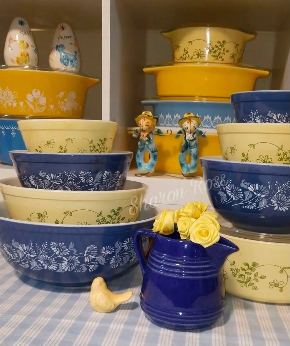 Blue and yellow floral bowls with a blue pitcher and yellow roses