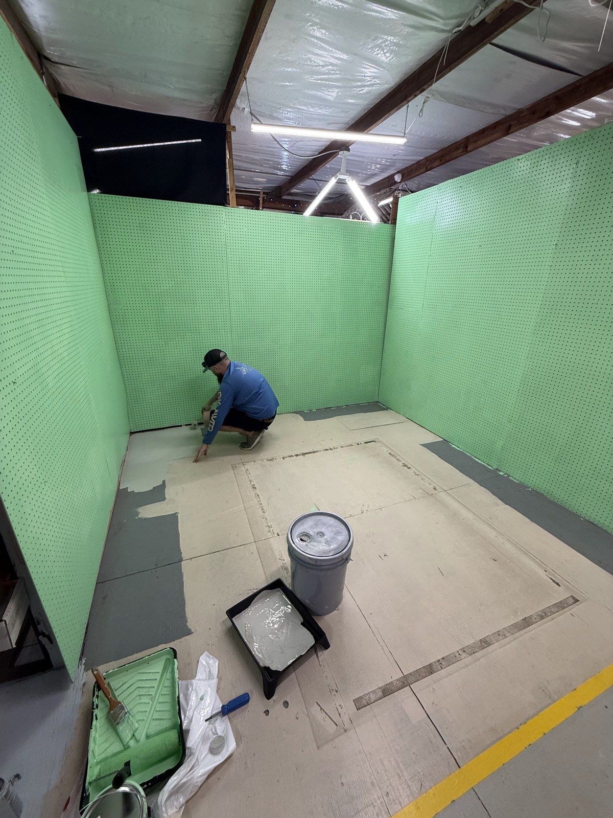 Preparing the floor of the green-walled booth at Feedstore