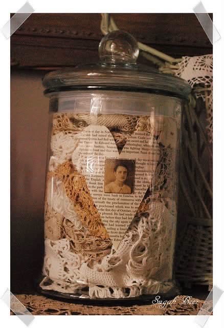 A glass jar filled with lace and a vintage portrait collage