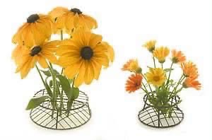 Yellow and orange flowers arranged in two wire dome flower frogs
