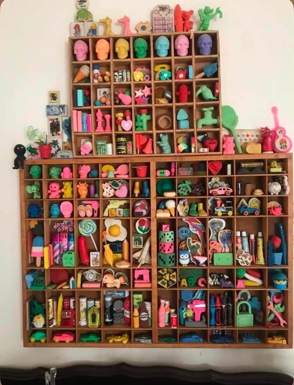 Two wooden shelves filled with colorful miniature collectibles