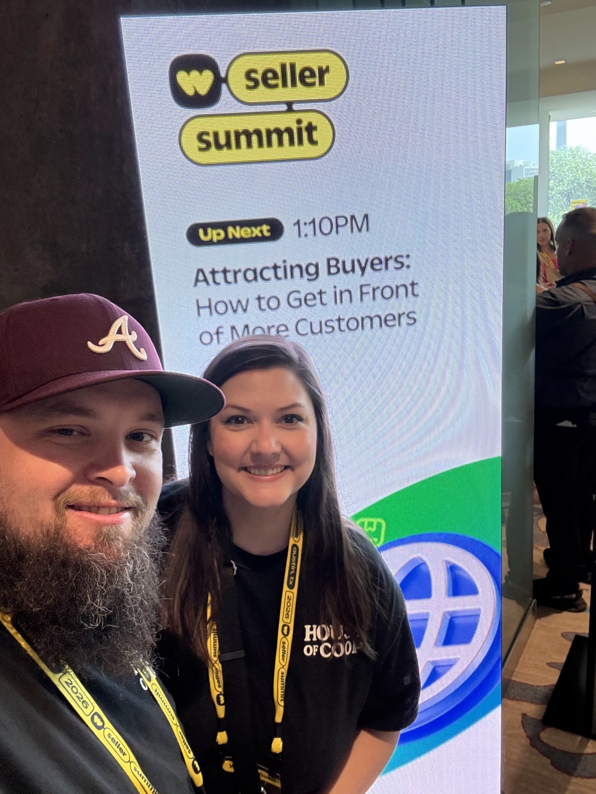 Ashley and Jacob beside the Seller Summit workshop sign