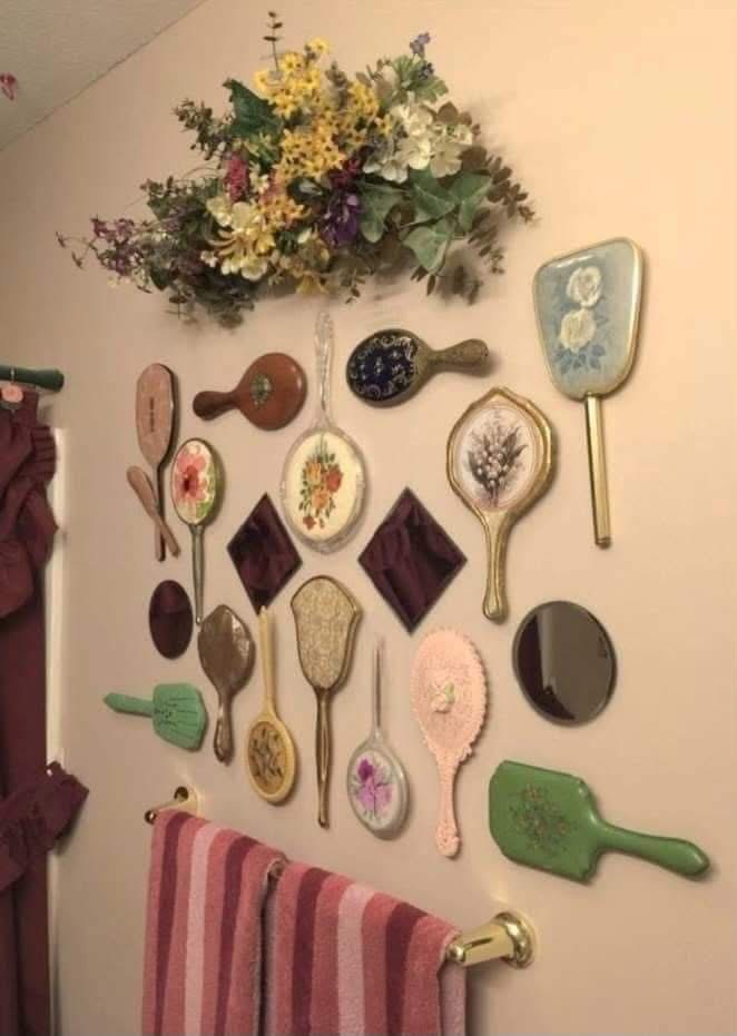 Decorative hand mirrors displayed above a bathroom towel rail