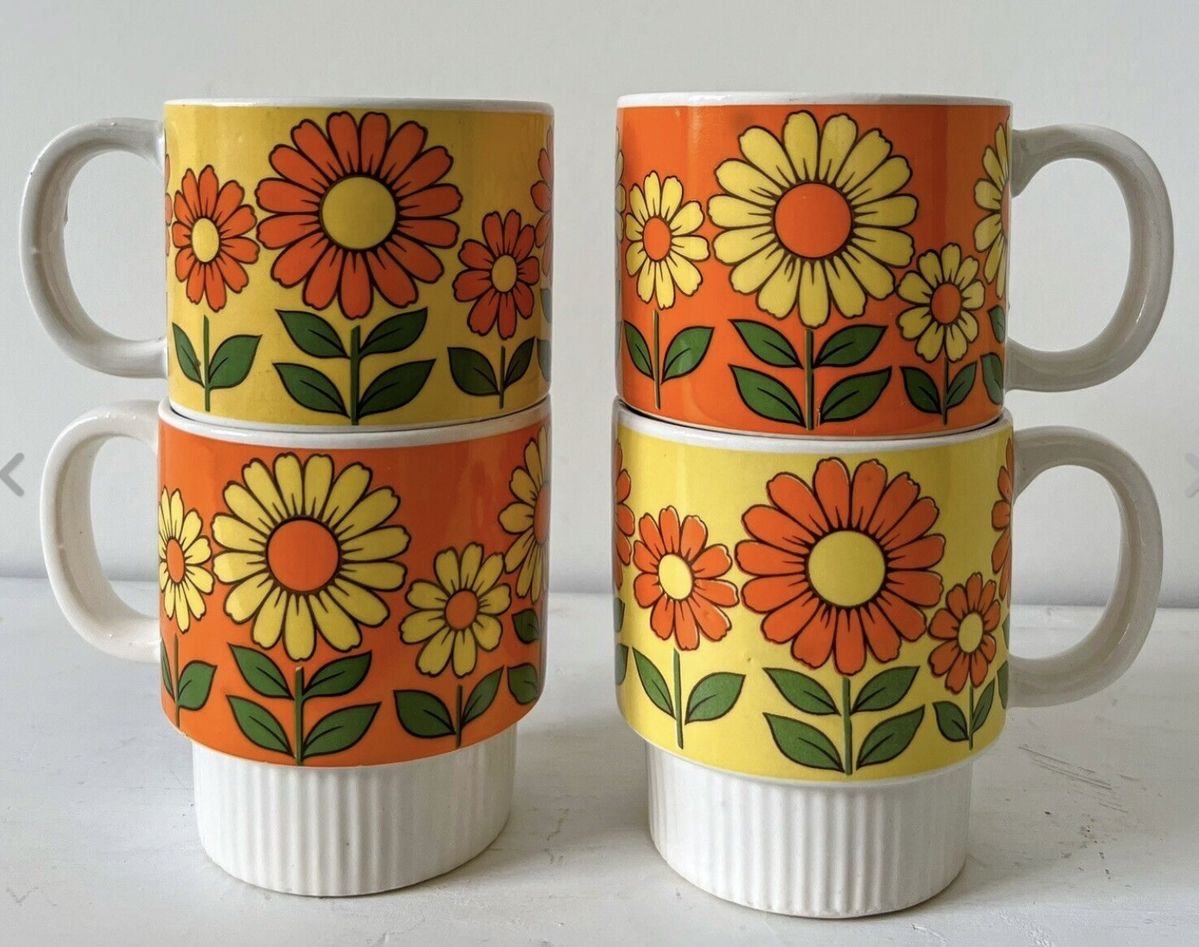 Four orange and yellow floral mugs