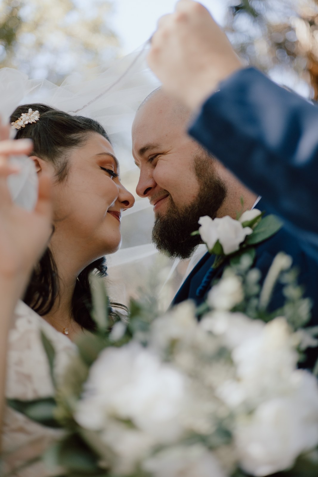 Ashley and Jacob together beneath the wedding veil
