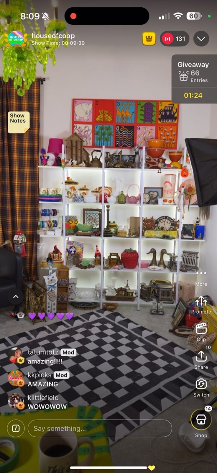 Whatnot livestream showing the decorated studio with green chandelier, colorful art and vintage shelves