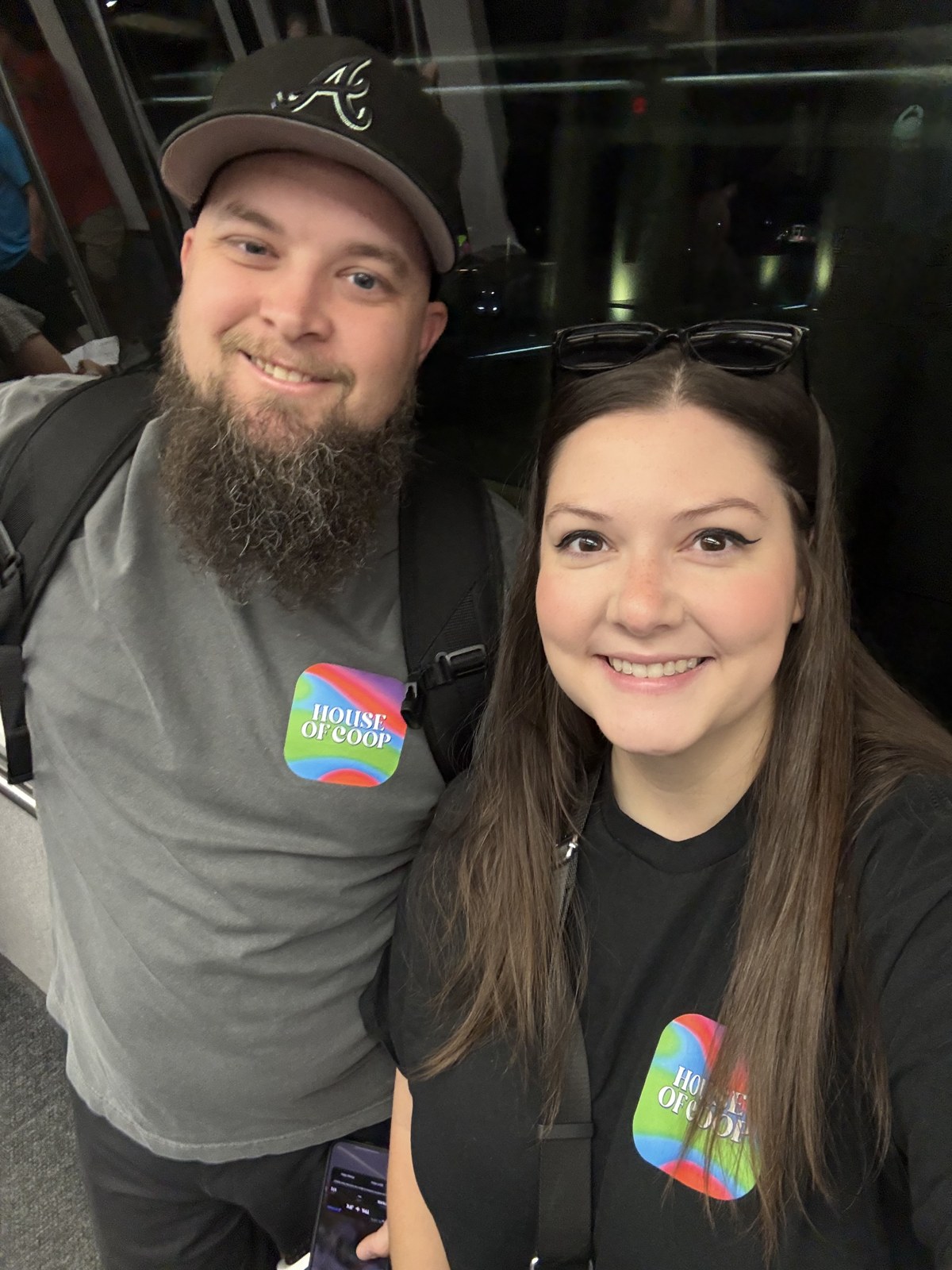 Ashley and Jacob smiling together in matching colorful House of Coop shirts