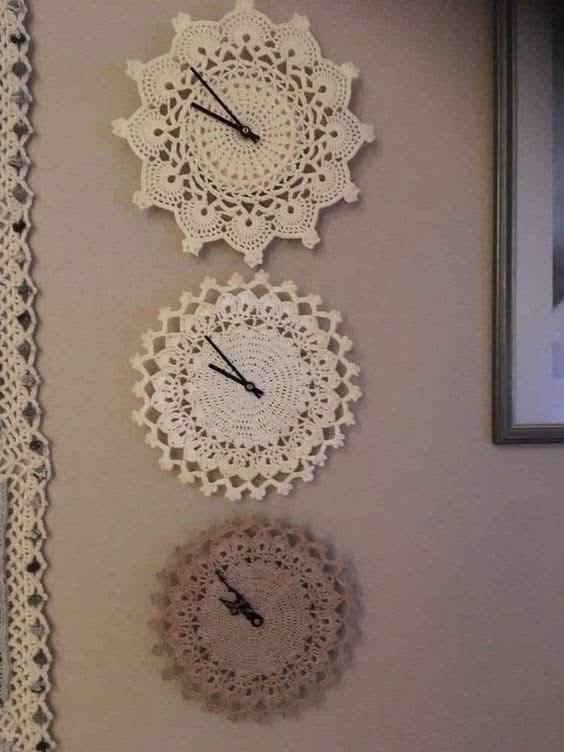 Three lace doilies used as wall clock faces