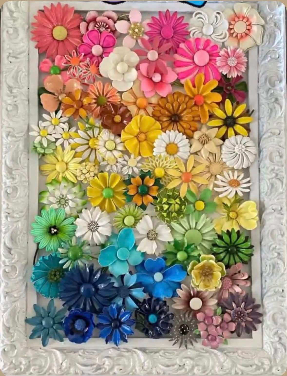 Rainbow colored flower brooches in a white ornate frame