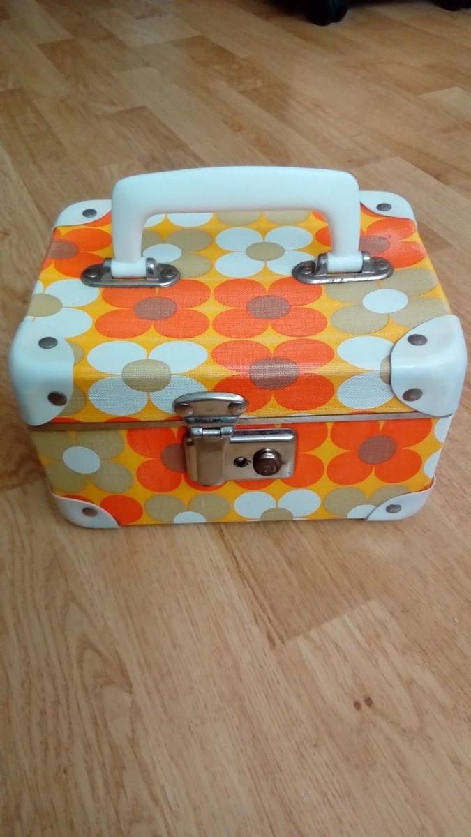 Small orange and white floral case with a white handle