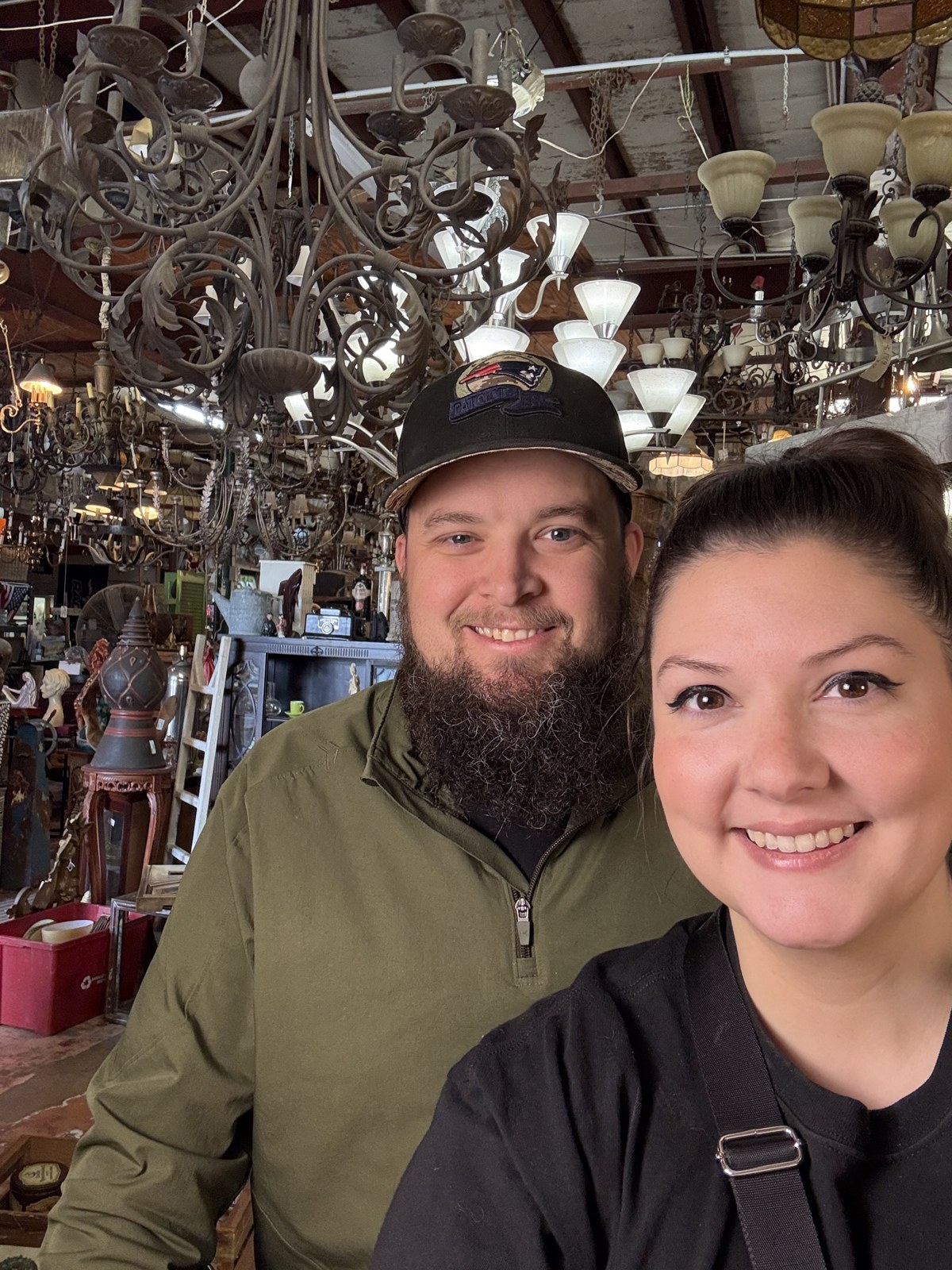 Ashley and Jacob together in an antique shop filled with vintage lighting