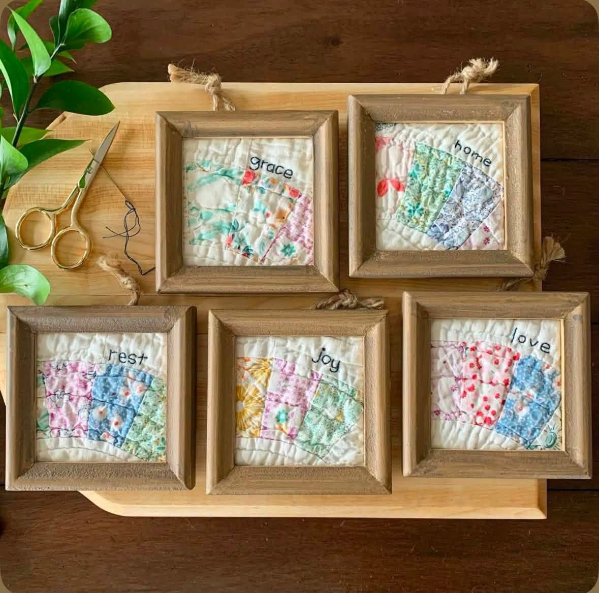 Small framed quilt pieces embroidered with grace home rest joy and love