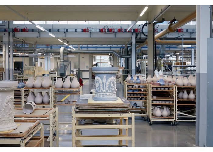Pottery factory interior with vessels on racks and worktables