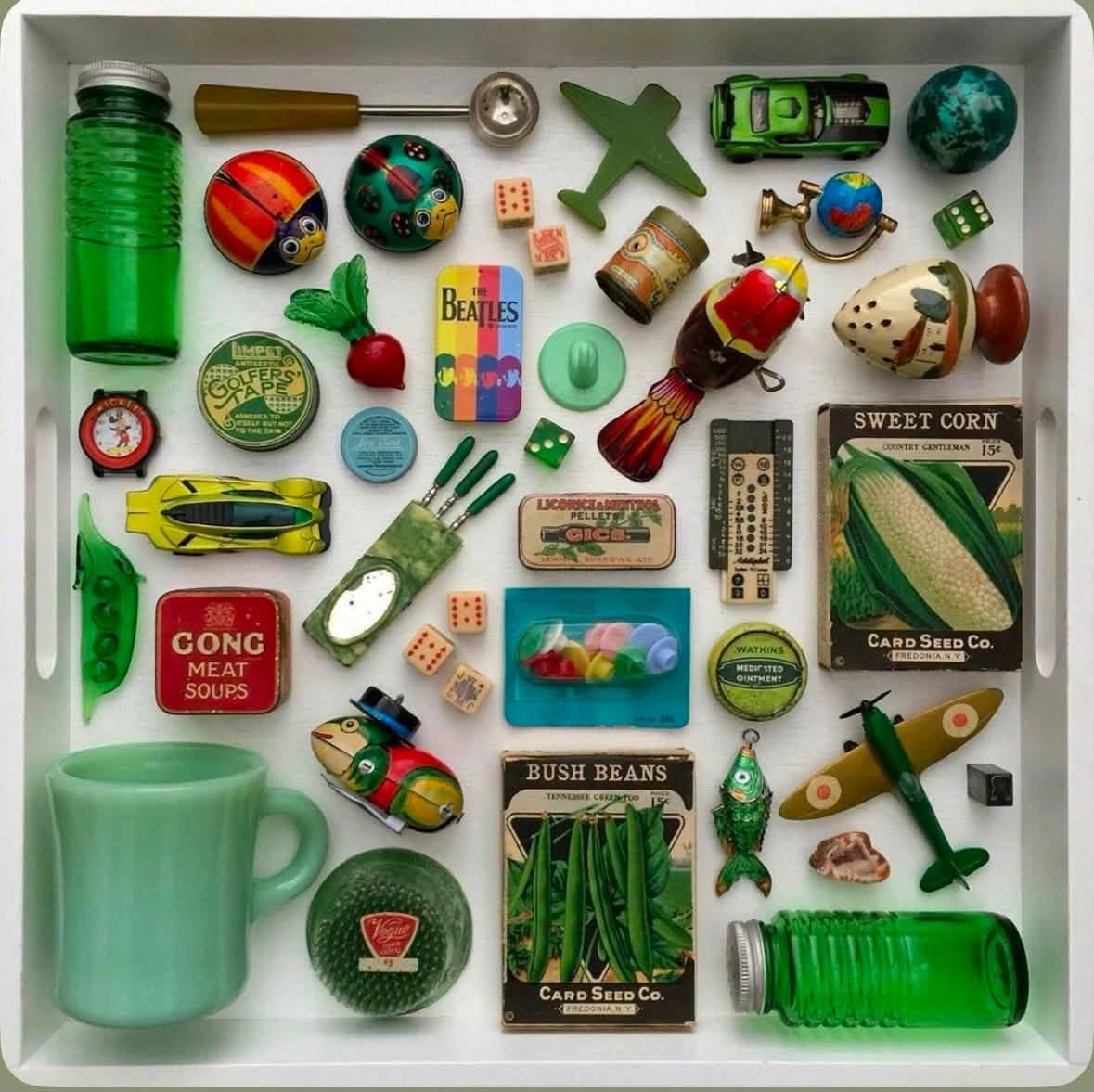 Green themed vintage objects arranged in a white tray