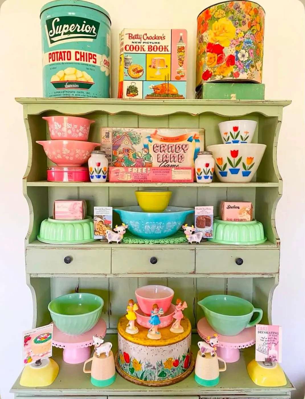 Pastel kitchenware and Pyrex bowls on a pale green hutch