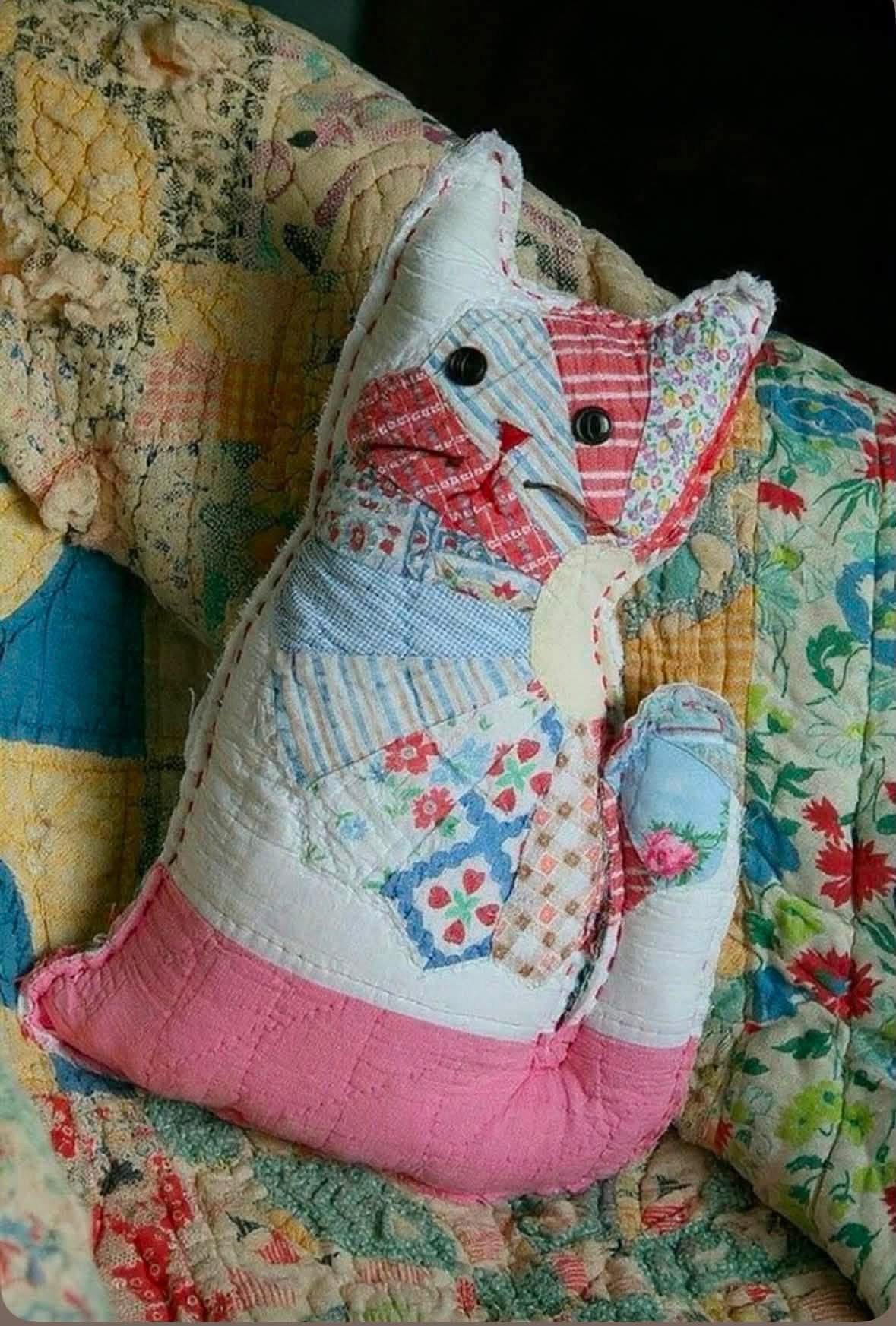 Cat shaped cushion made from pastel quilt pieces