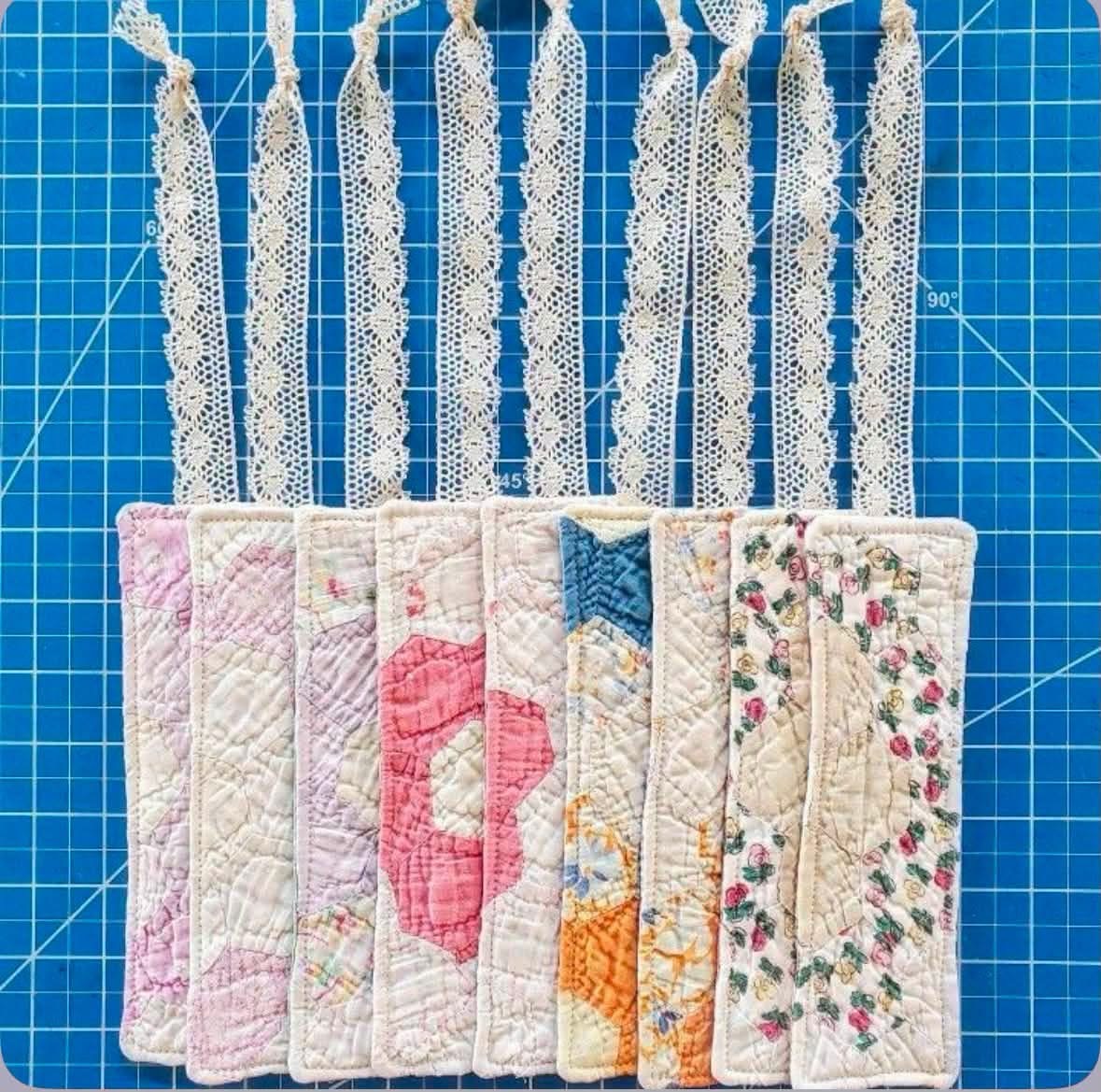 Quilted bookmarks with lace ribbons on a cutting mat