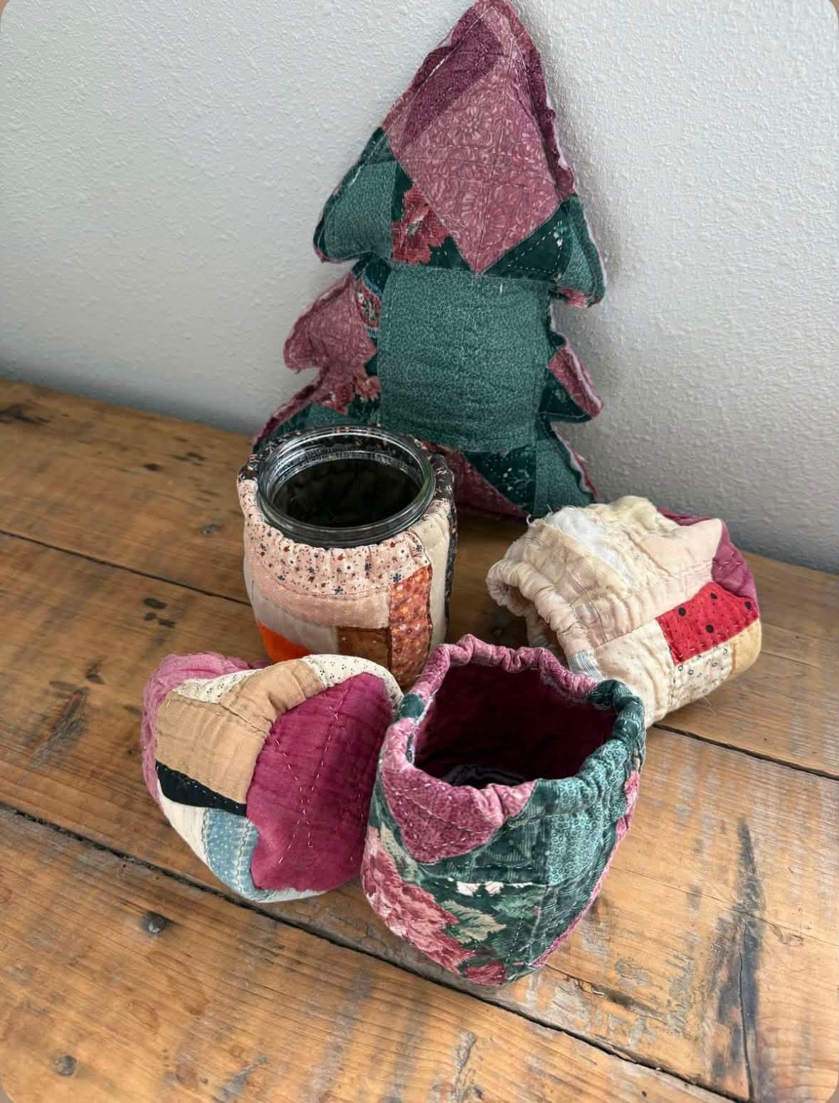 Quilted tree heart and fabric baskets arranged on a wooden table
