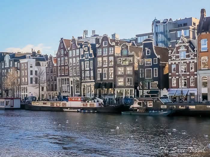 Amsterdam waterfront lined with narrow historic gabled houses