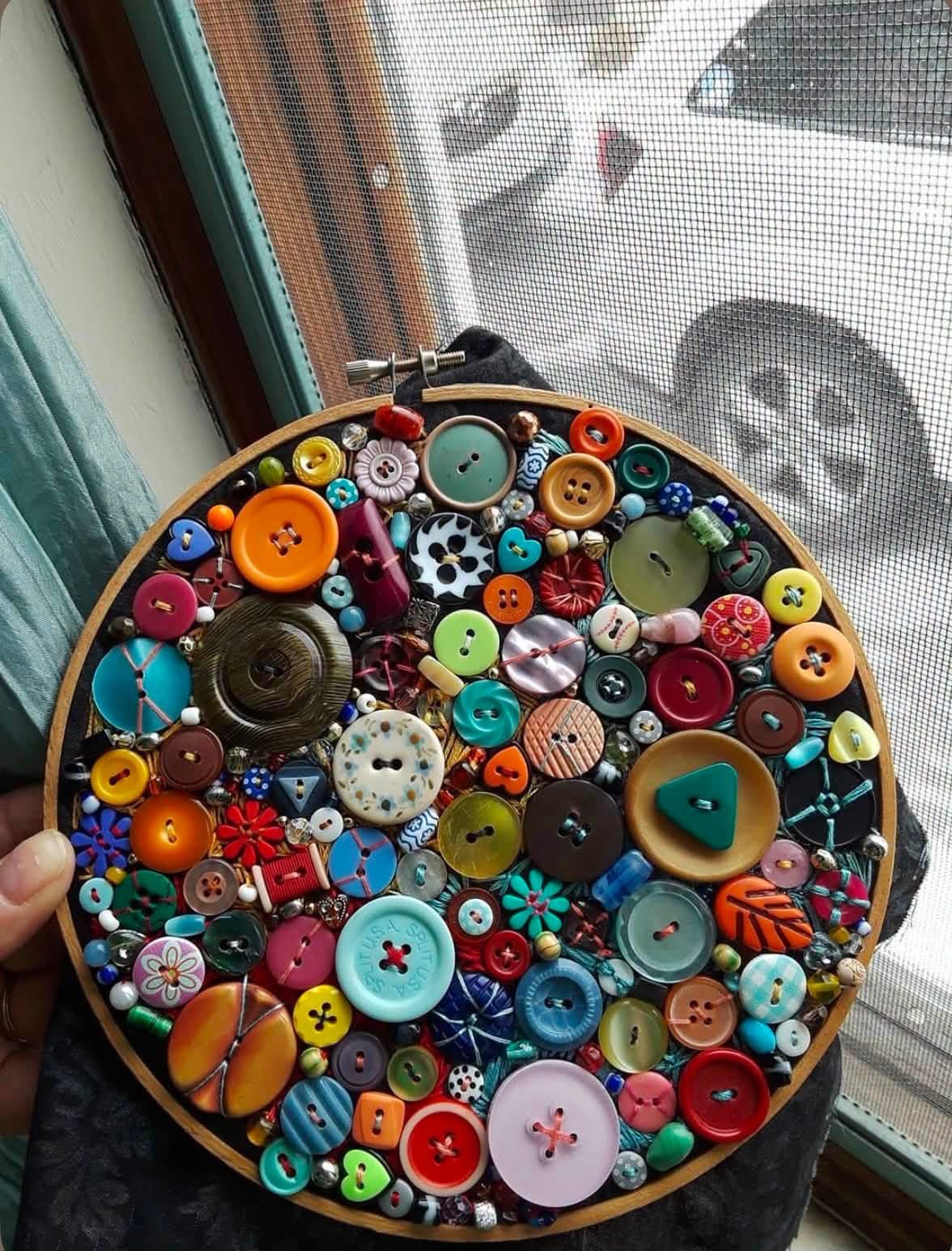Colorful buttons and beads stitched into a round embroidery hoop
