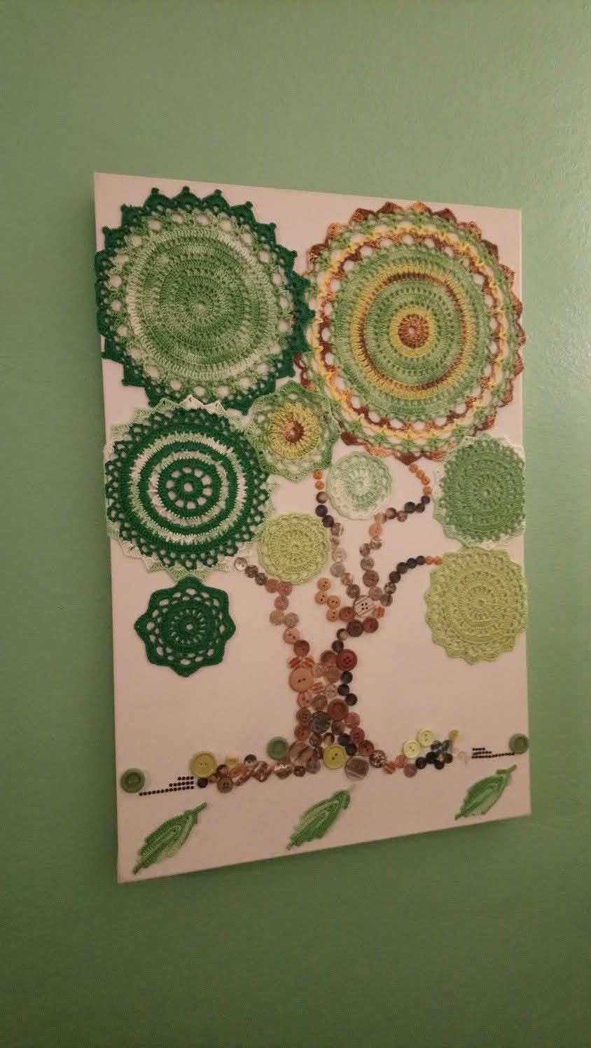A tree picture made from green doilies and buttons