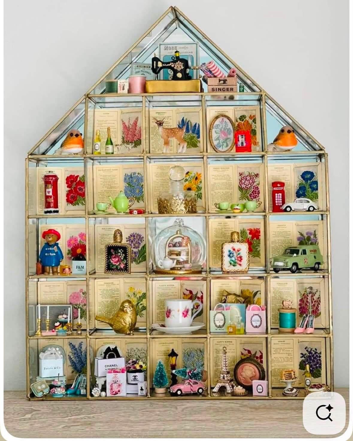 House shaped display with floral backgrounds and miniature keepsakes