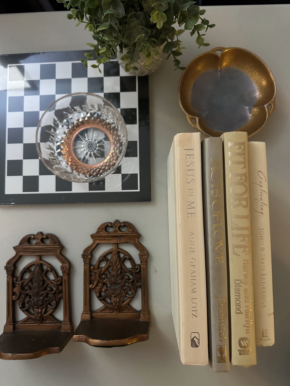 Framed checkerboard art, books and decorative vintage pieces