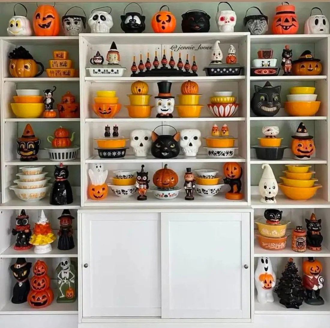 Orange yellow and black bowls displayed with Halloween decorations