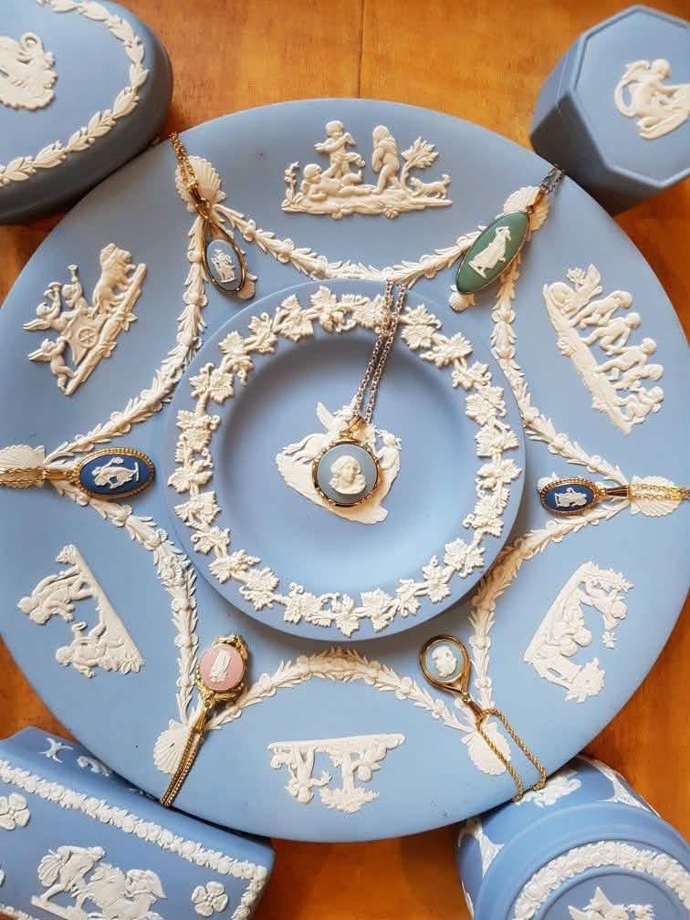 Cameo jewelry arranged over blue Jasperware plates