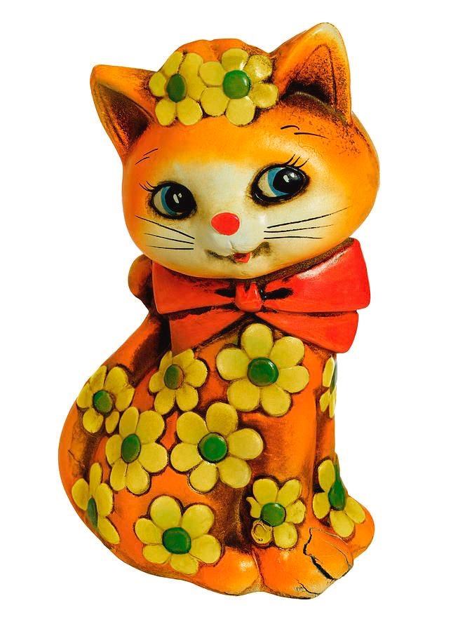 Orange cat figurine with yellow flowers and a red bow