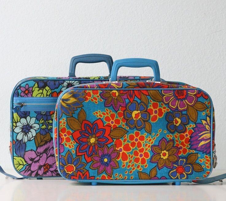Two blue handled floral suitcases
