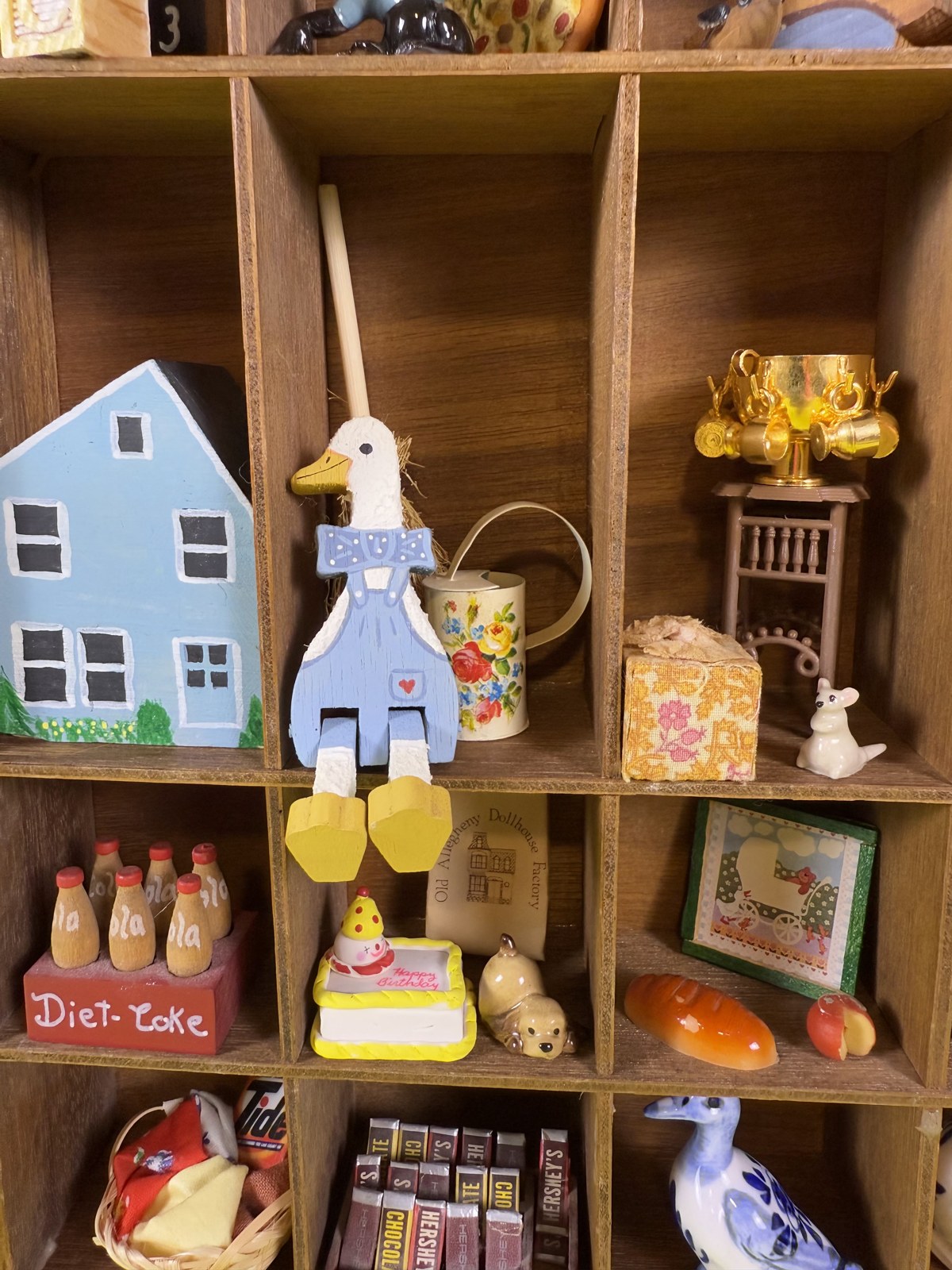 Miniature houses, a goose and tiny bottles on the shelves