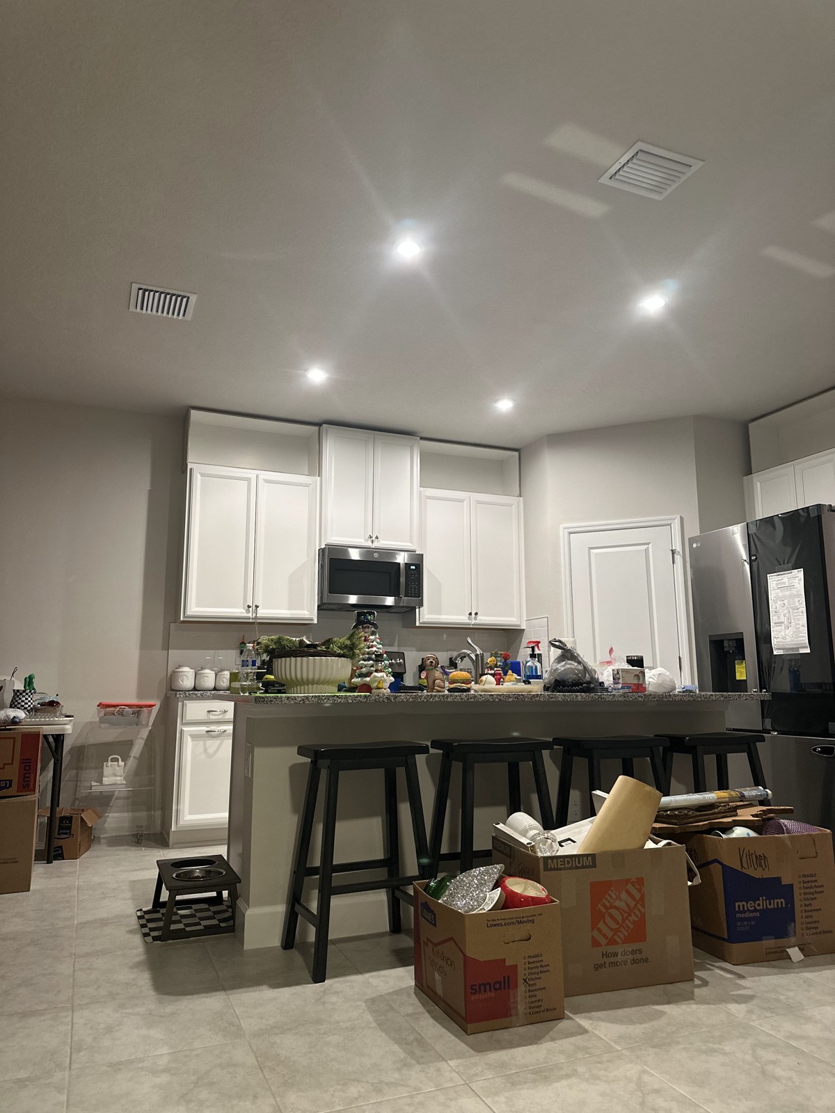Kitchen with moving boxes in December 2023
