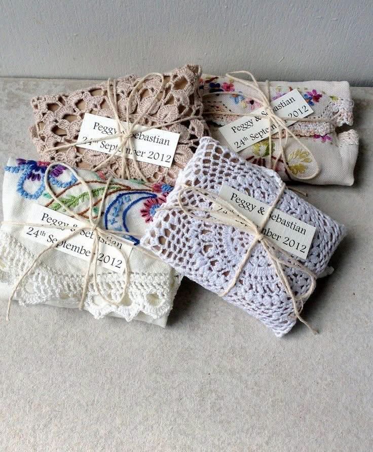Small fabric wrapped gifts tied with twine and trimmed with lace