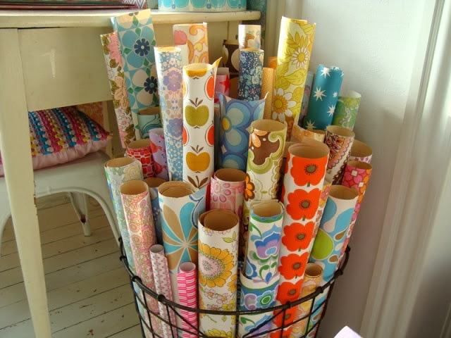 Rolls of vintage floral wallpaper in a basket