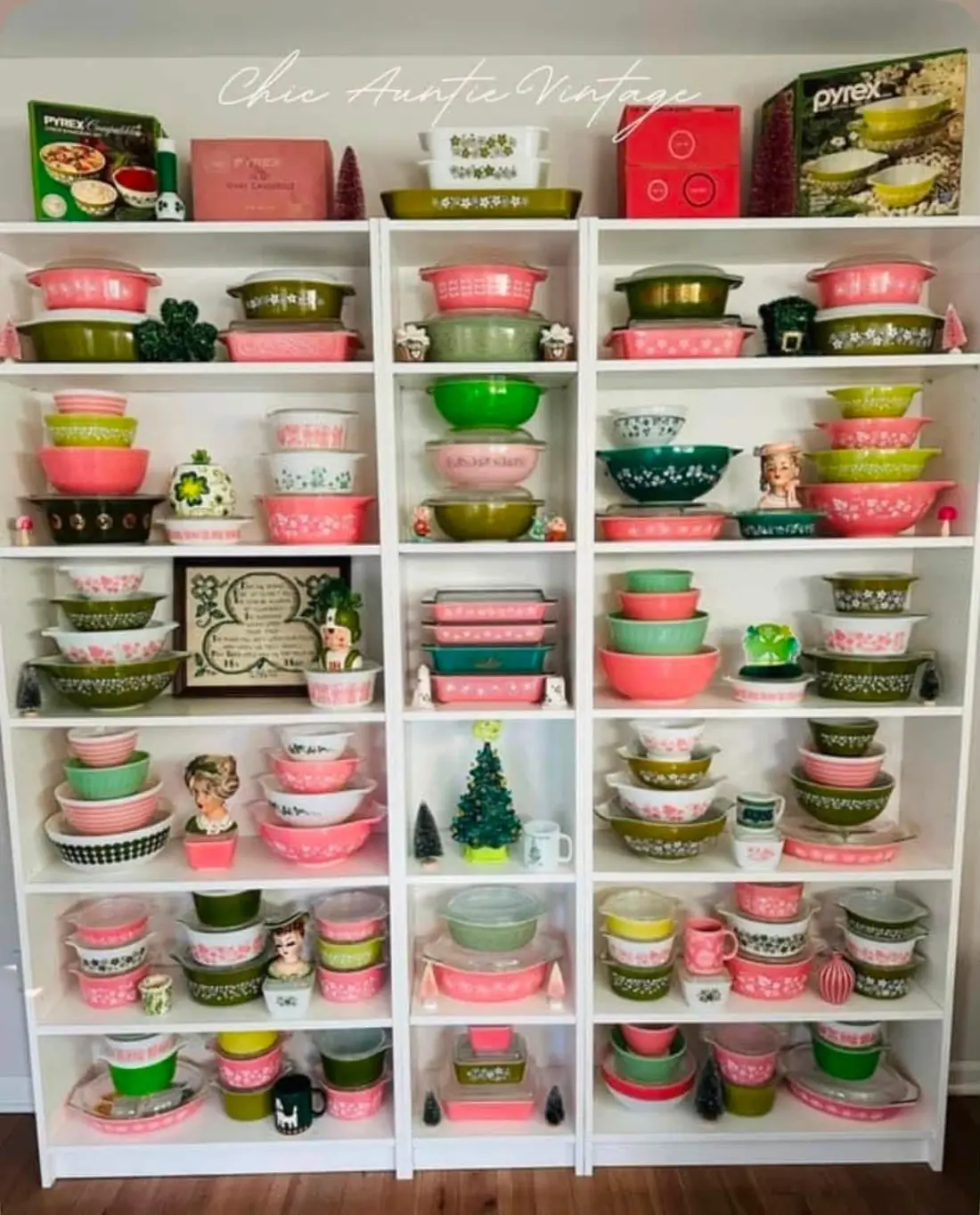 Pink and green patterned Pyrex on white shelves