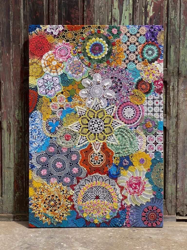 A colorful collage of overlapping crochet doilies