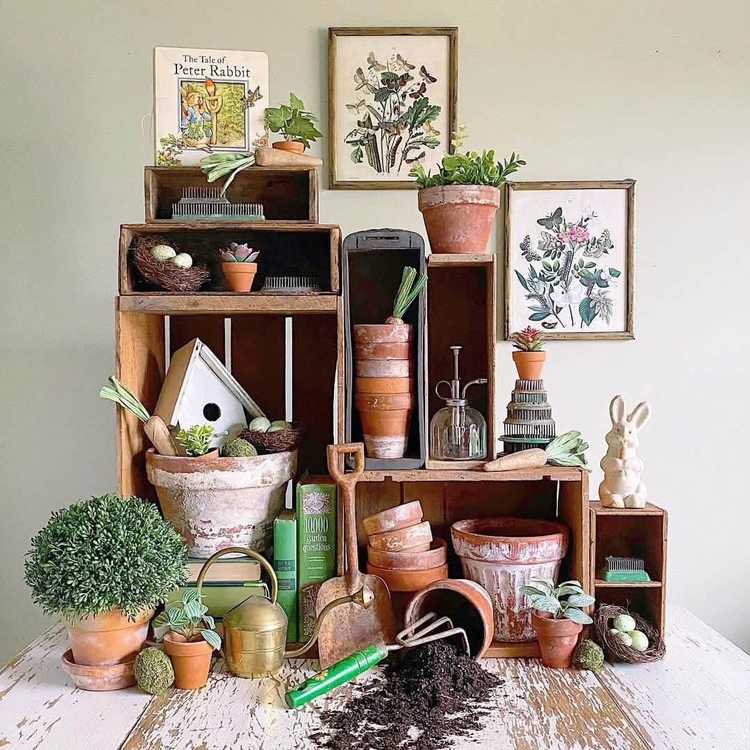 Spring display of wooden crates, terracotta pots and pin flower frogs