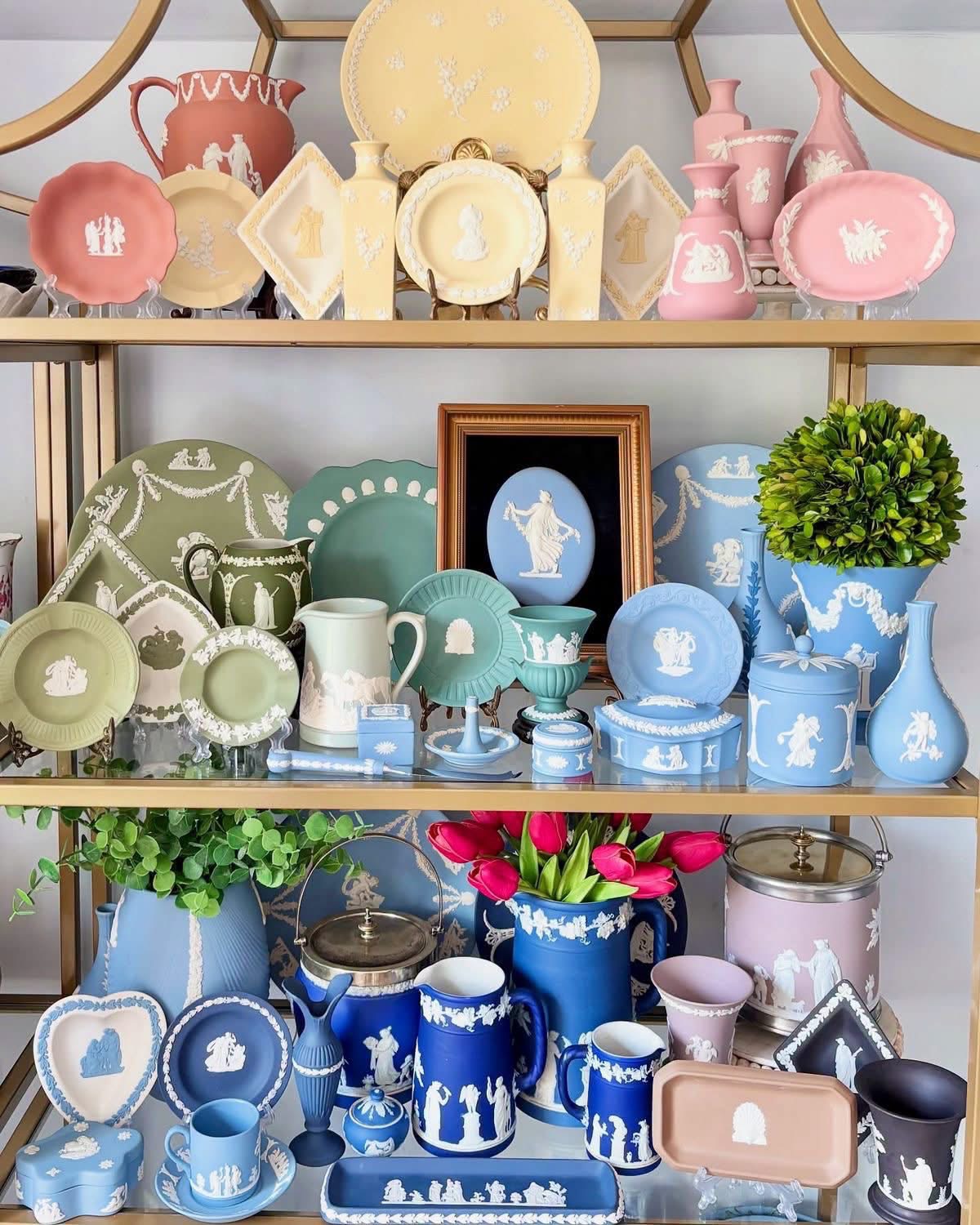 Colorful Jasperware in pink, yellow, green, lilac and blue on gold shelves