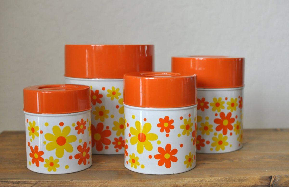 Orange lidded canisters with yellow and orange daisies