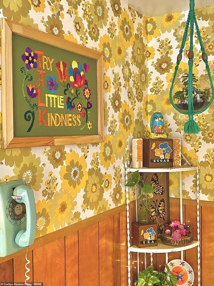 Yellow floral wallpaper with embroidered kindness artwork