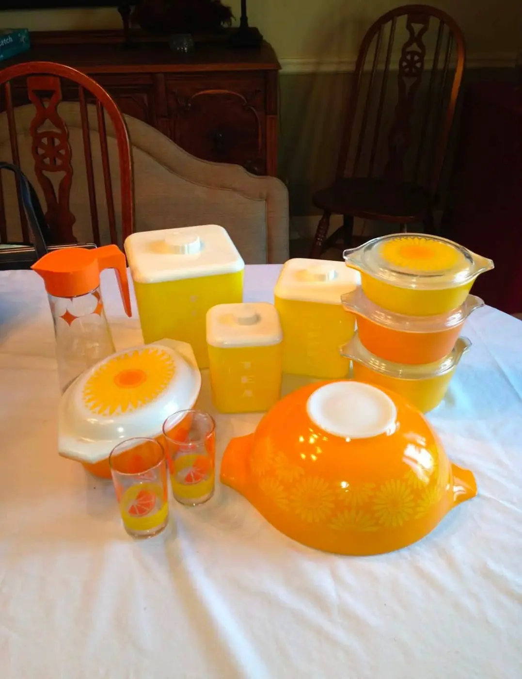 Yellow and orange kitchenware with covered Pyrex casseroles