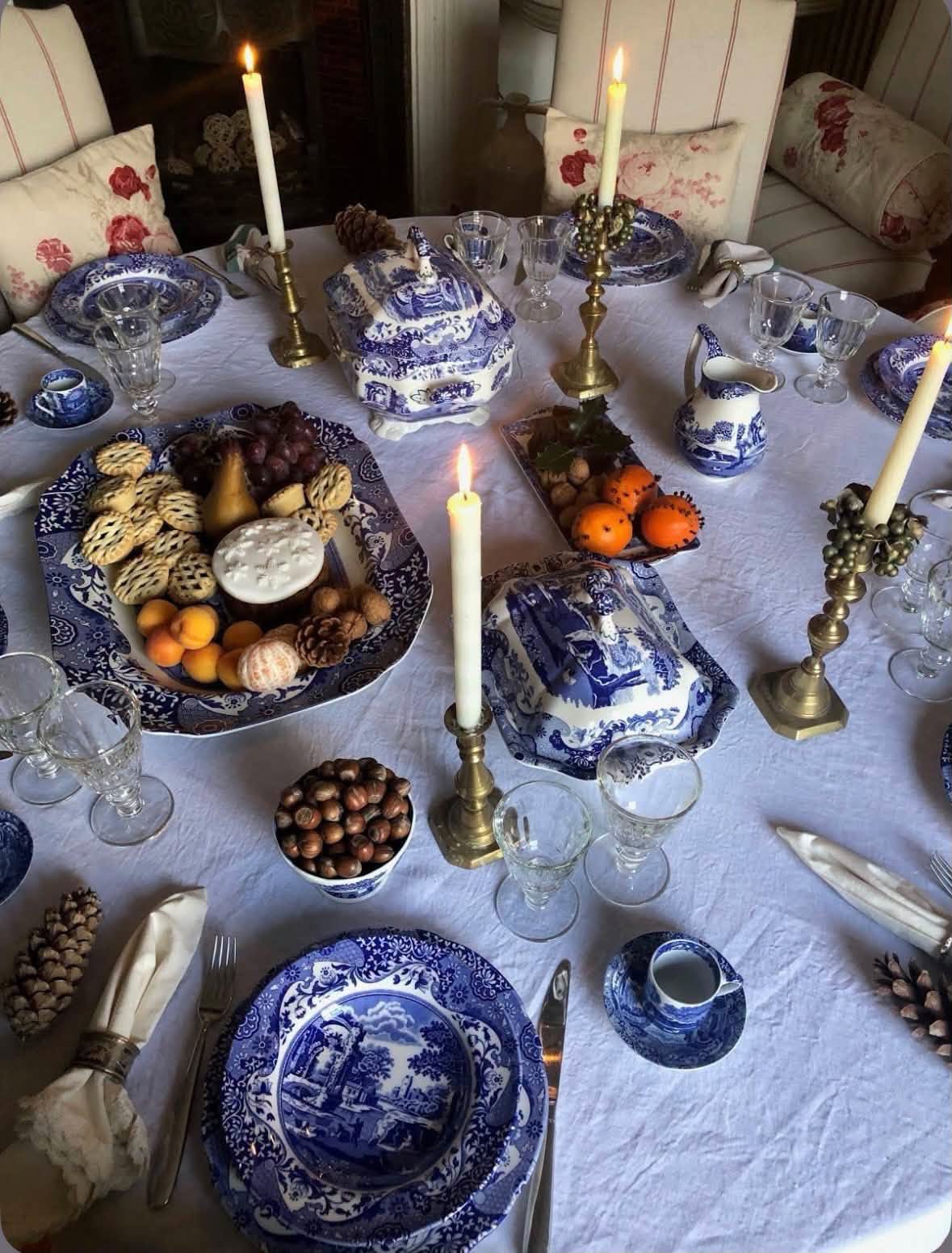 A candlelit table set with blue and white dishes