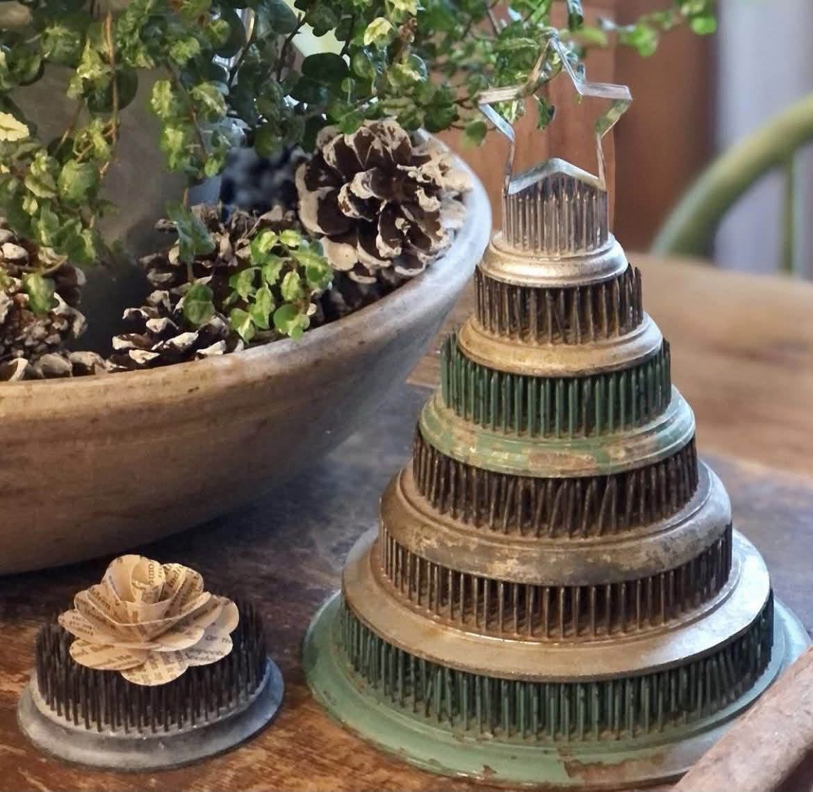 Stacked pin flower frogs forming a Christmas tree topped with a star