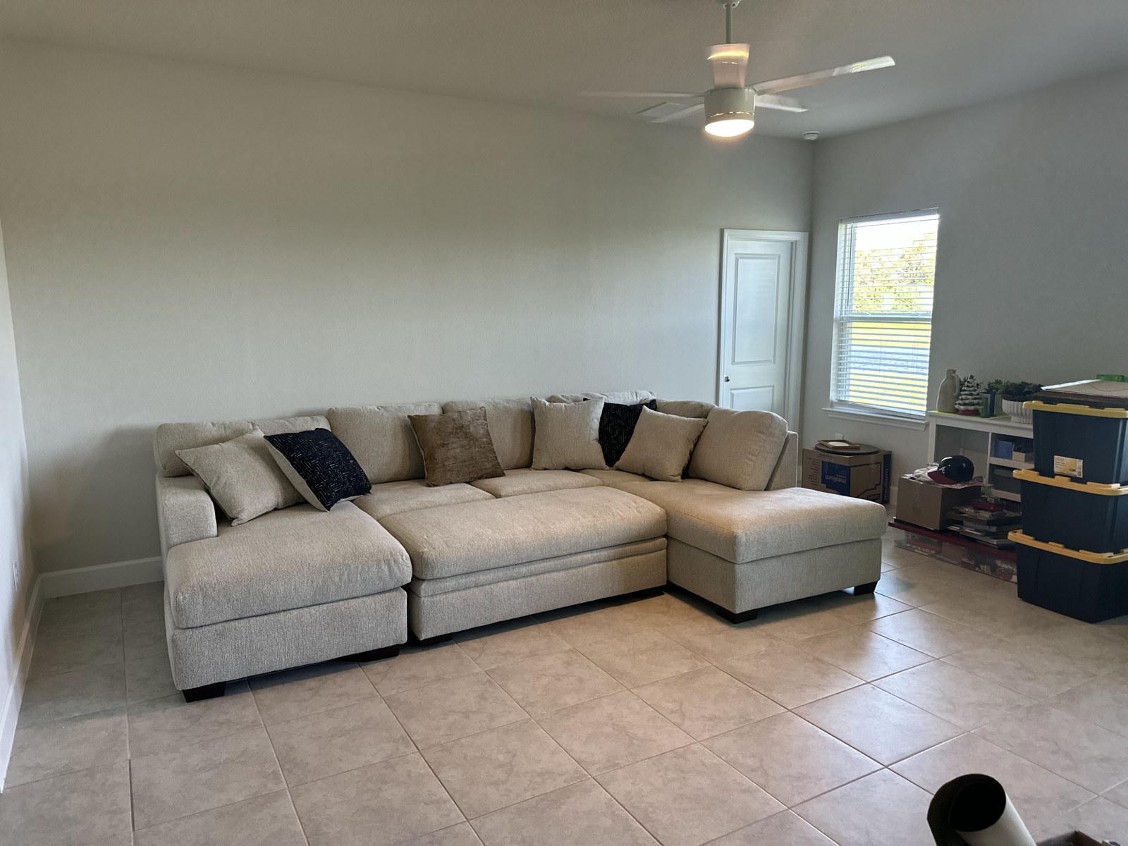 Living room with a sofa and moving boxes in the first home