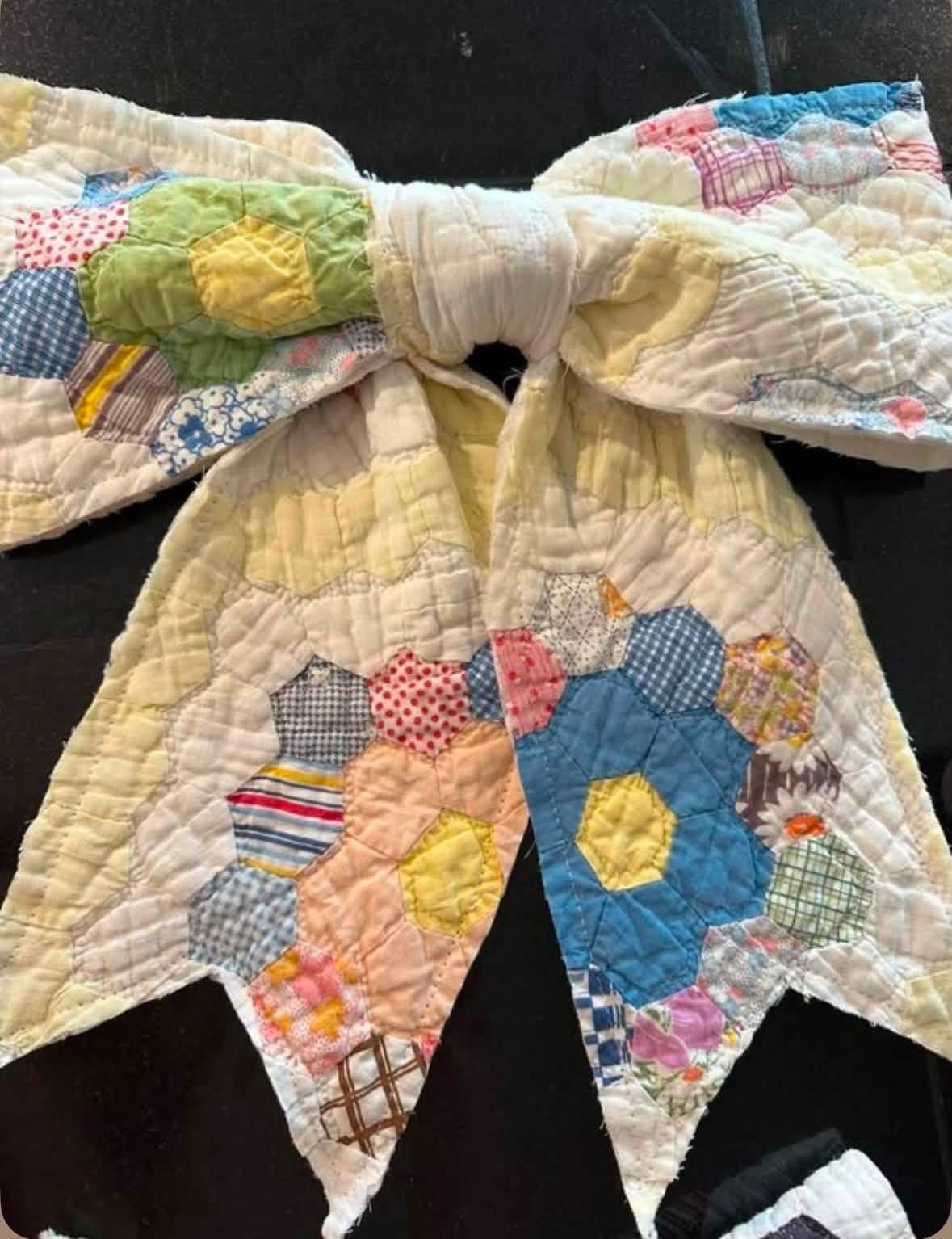 Large decorative bow made from floral patchwork quilt fabric