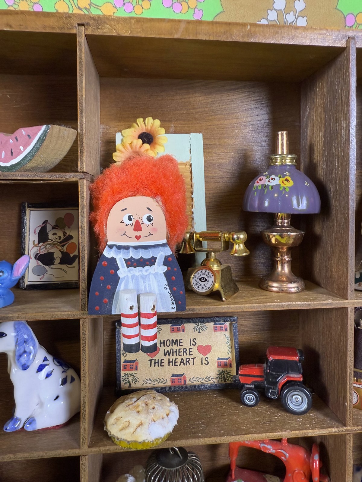 A miniature doll, lamp and toy truck in the display